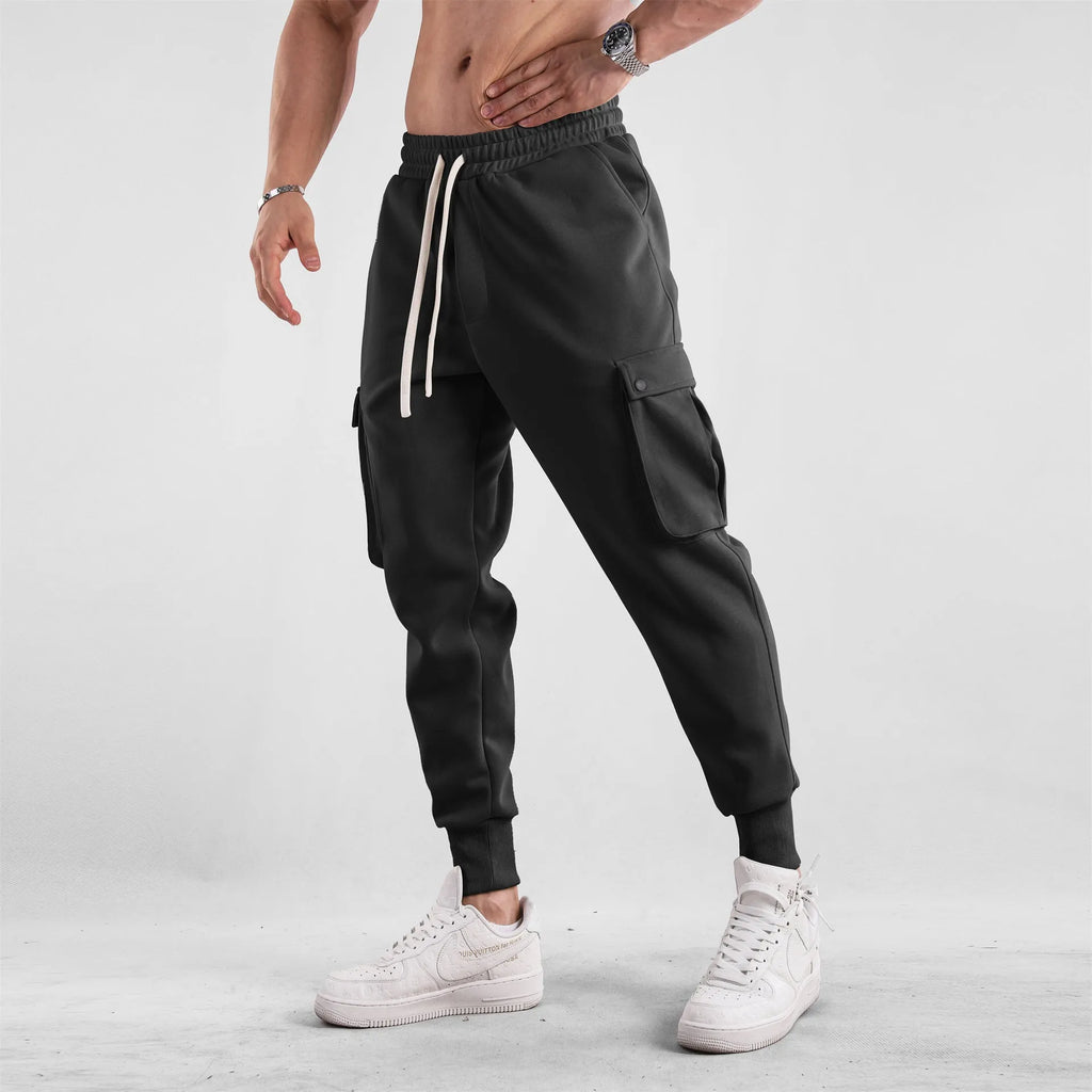 Men's loose-fit cotton sports trousers with ankle ties and multiple pockets in solid colour