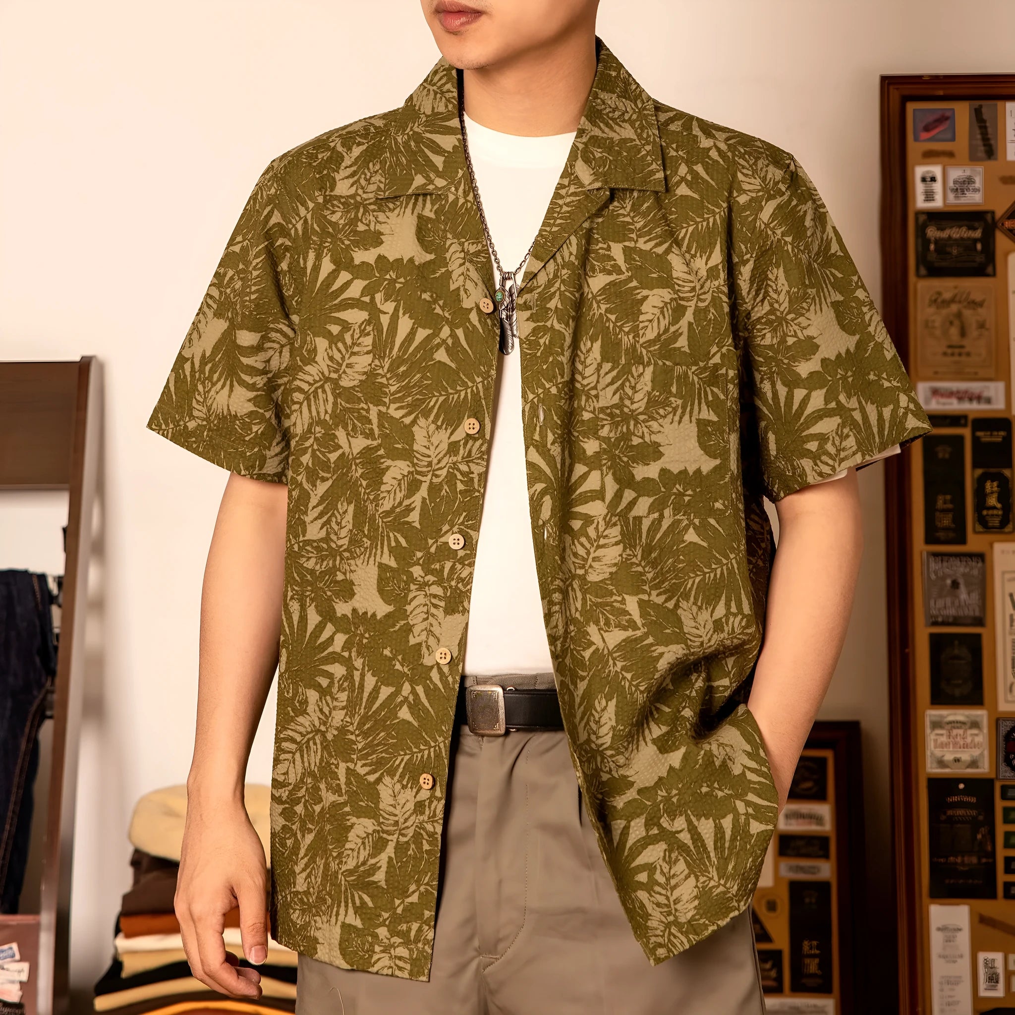 Vintage floral print seersucker shirt with a Cuban collar on a mannequin, shown in blue and green.