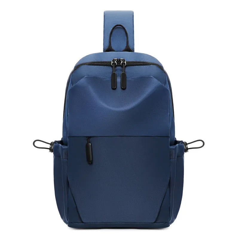 Grey men's chest bag worn across the shoulder, showing main compartment and waterproof-treated fabric.