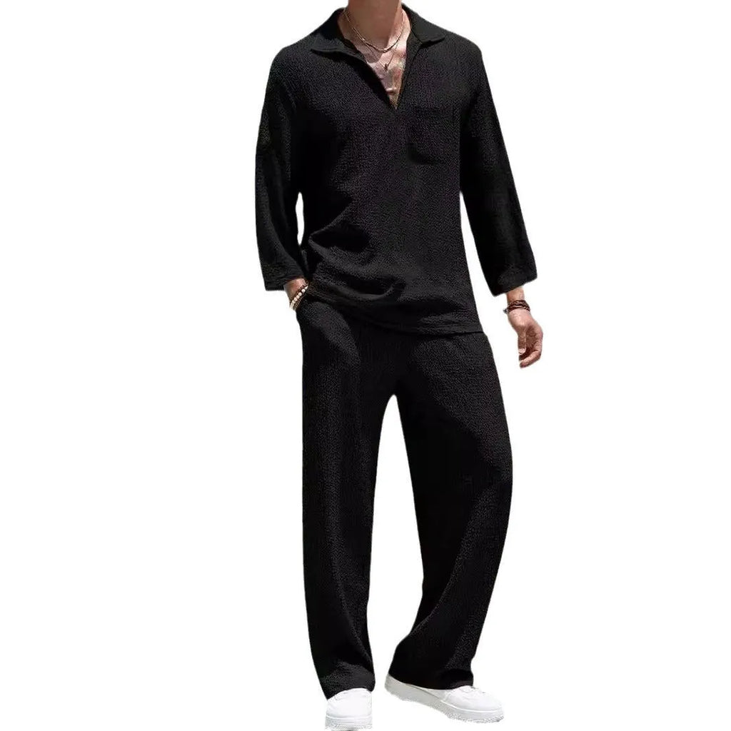 Man wearing a casual lake blue polyester shirt and matching trousers from a two-piece suit set.