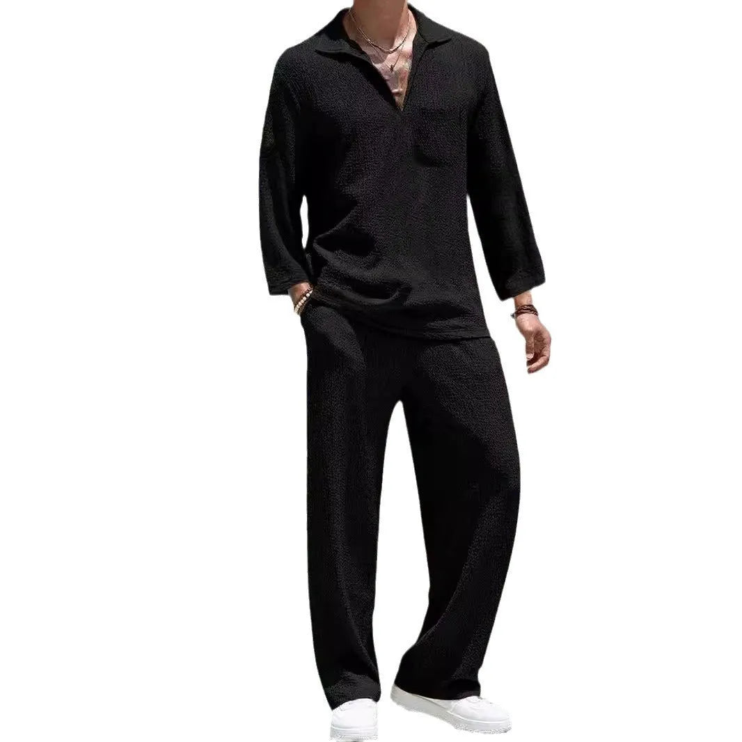 Man wearing a casual lake blue polyester shirt and matching trousers from a two-piece suit set.