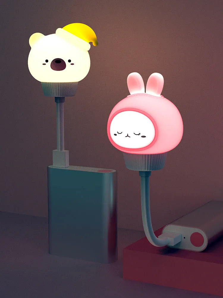 USB portable LED night light with remote control in cartoon bear design on bedside table