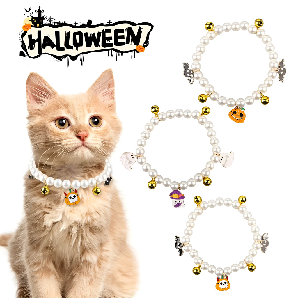 Set of three pet necklaces: a pearl strand, a Halloween cat collar, and a dog bell ornament on a table.