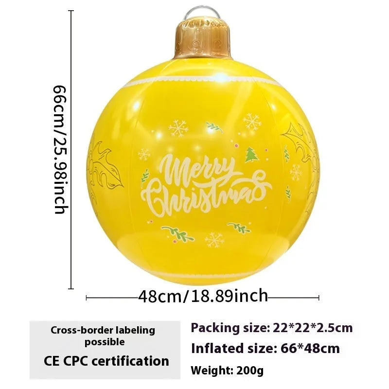Large red and white inflatable Christmas ball with flashing lights standing in a garden.