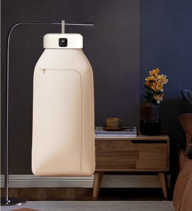 White cylindrical portable clothes dryer with remote control, folded for compact storage