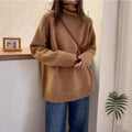Women's thick grey turtleneck sweater with a textured curling pile collar, loose casual fit.
