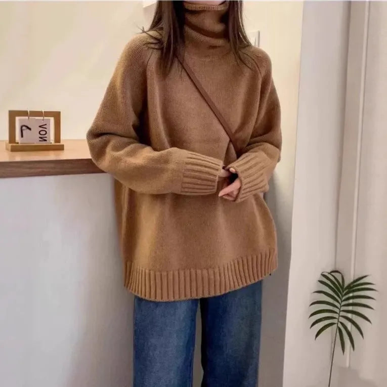 Women's thick grey turtleneck sweater with a textured curling pile collar, loose casual fit.