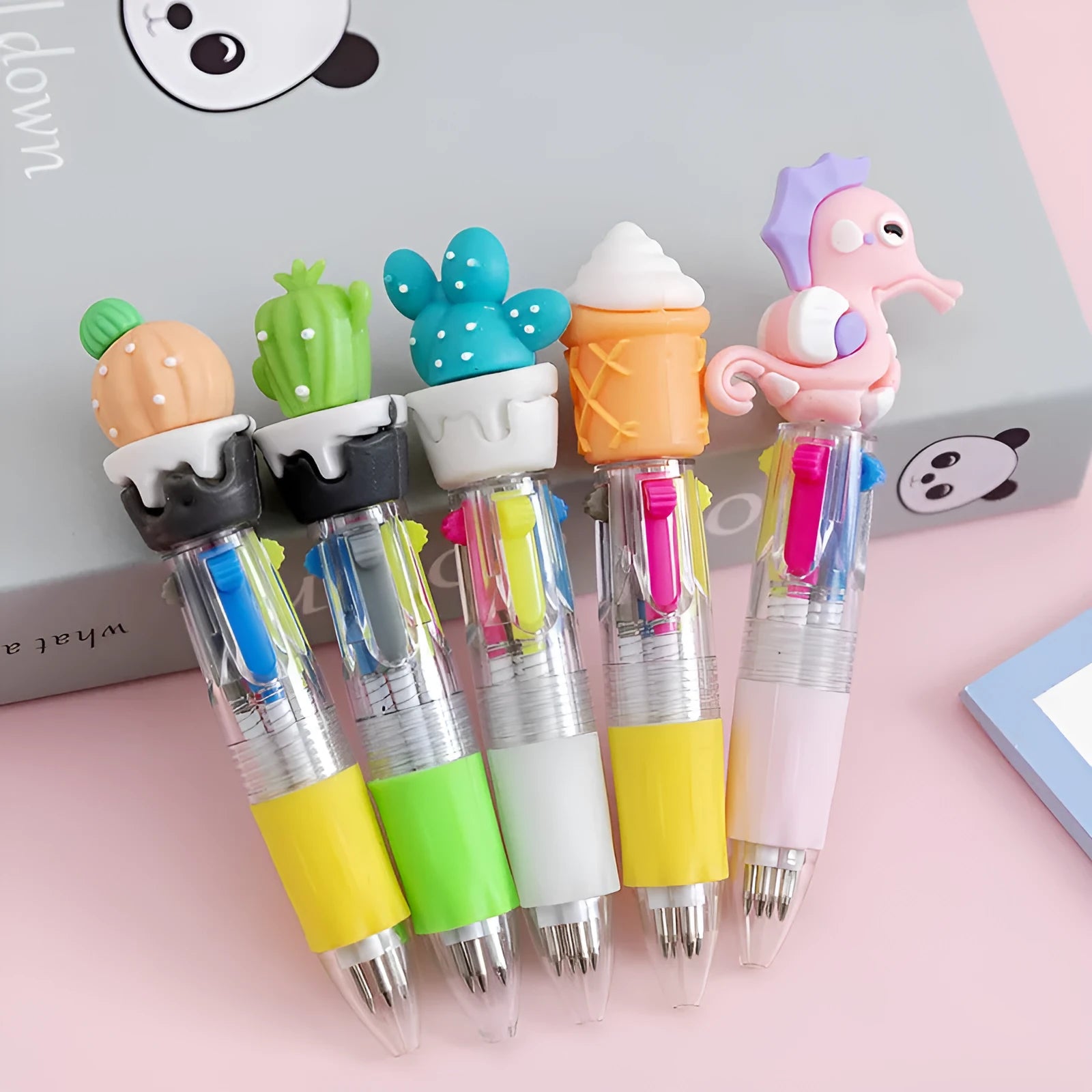 Four-colour press ballpoint pen with random cartoon design and silicone grip.