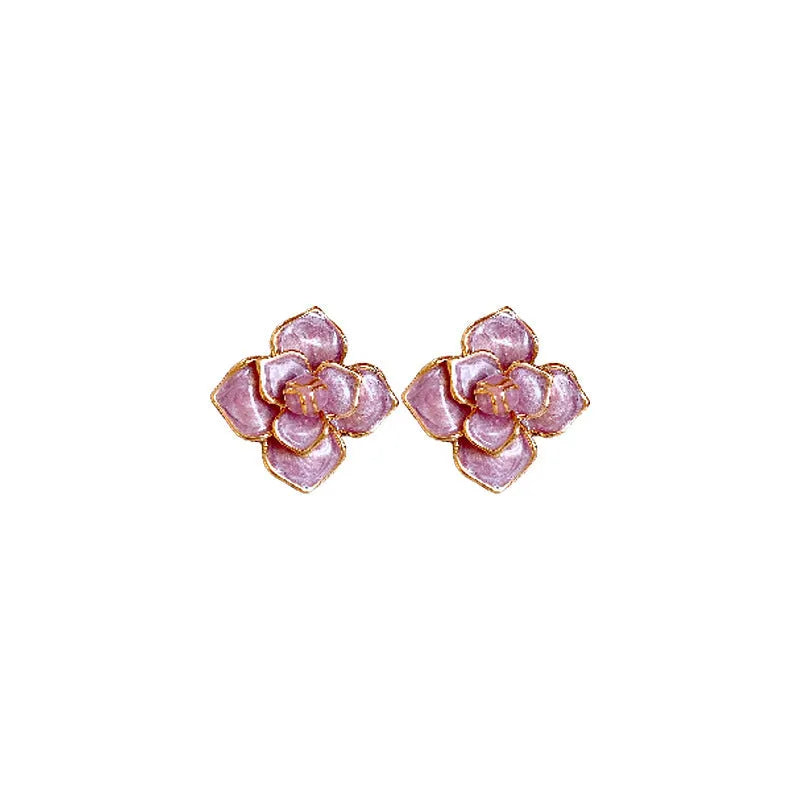 A pair of gold-plated purple flower stud earrings with a mottled oil-spot glaze on a copper base.