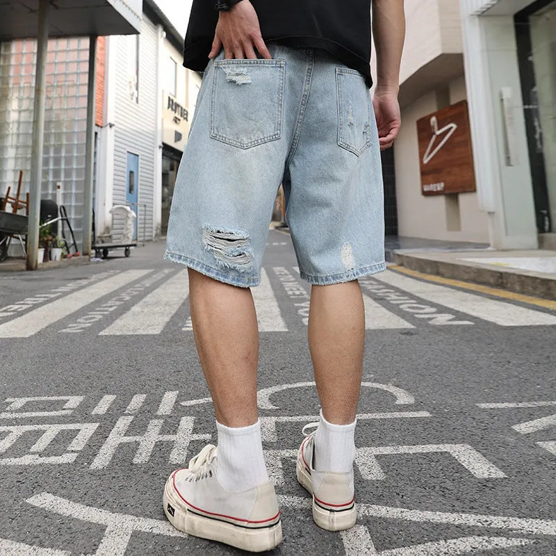 Light blue ripped denim shorts with distressed detailing and straight leg hip hop styling