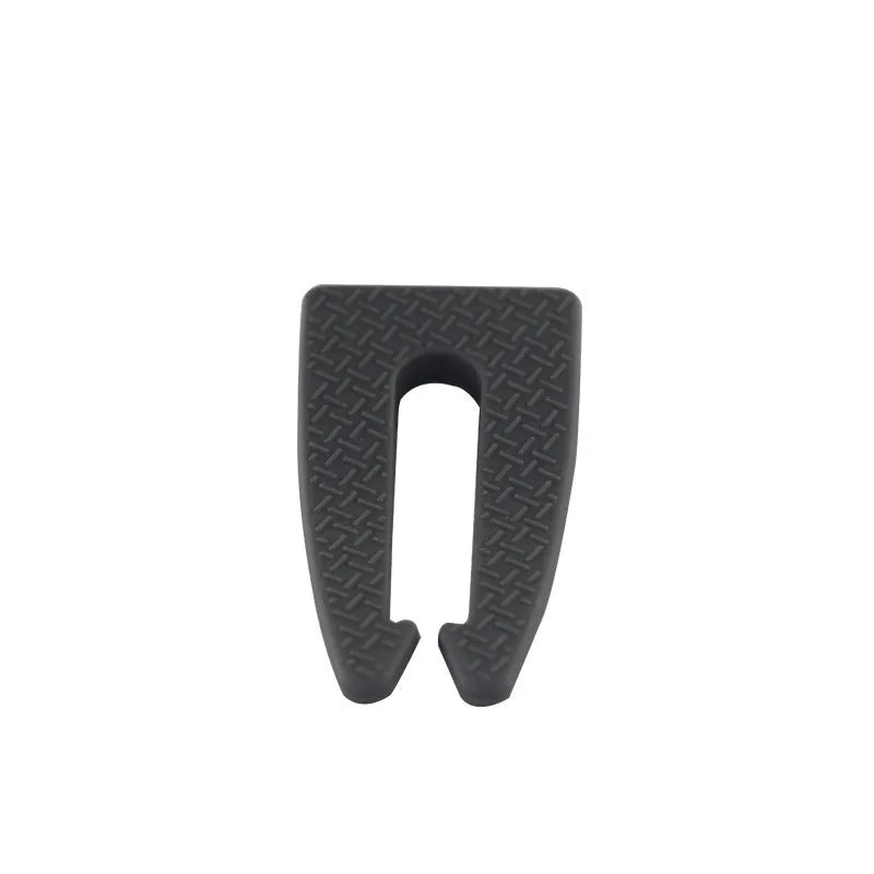 Gray plastic gas stove knob safety lock clipped onto a gas cooker knob showing side profile