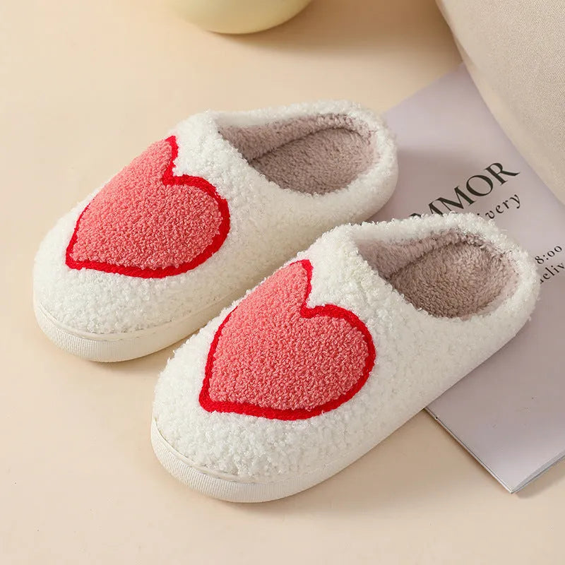 Women's plush home slipper with cartoon graphic print and non-slip PVC sole.
