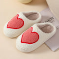 Women's plush home slipper with cartoon graphic print and non-slip PVC sole.