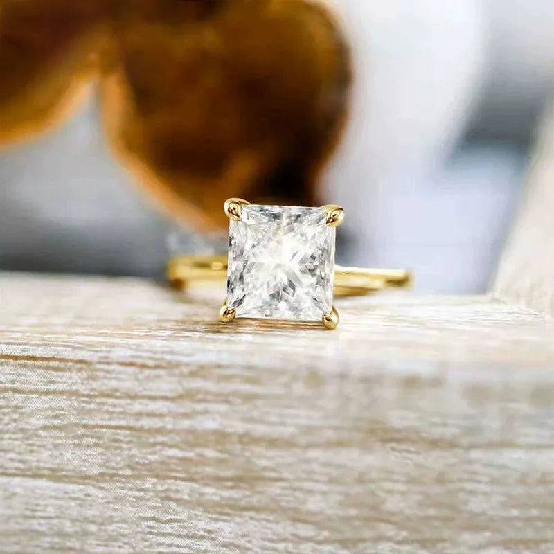 A simple geometric sterling silver ring with a round zirconia stone, shown in silver, gold, and rose gold finishes.