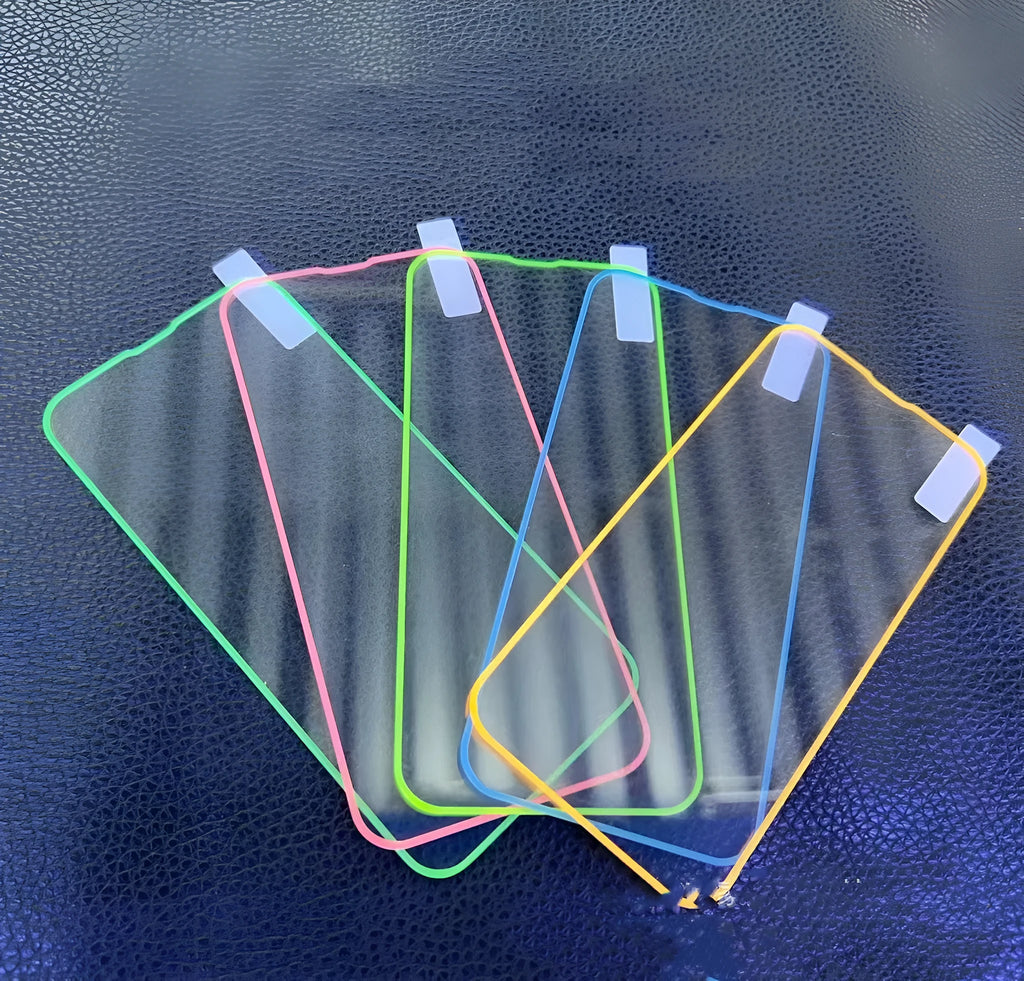 Fluorescent pink tempered glass screen protector applied to an iPhone 13 Pro, glowing softly on a dark background.