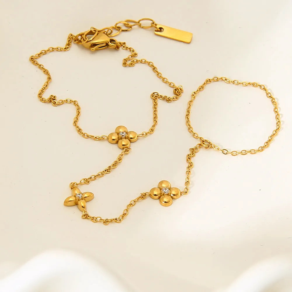 Women's stainless steel bracelet with geometric flower and eight-pointed star charms in gold colour