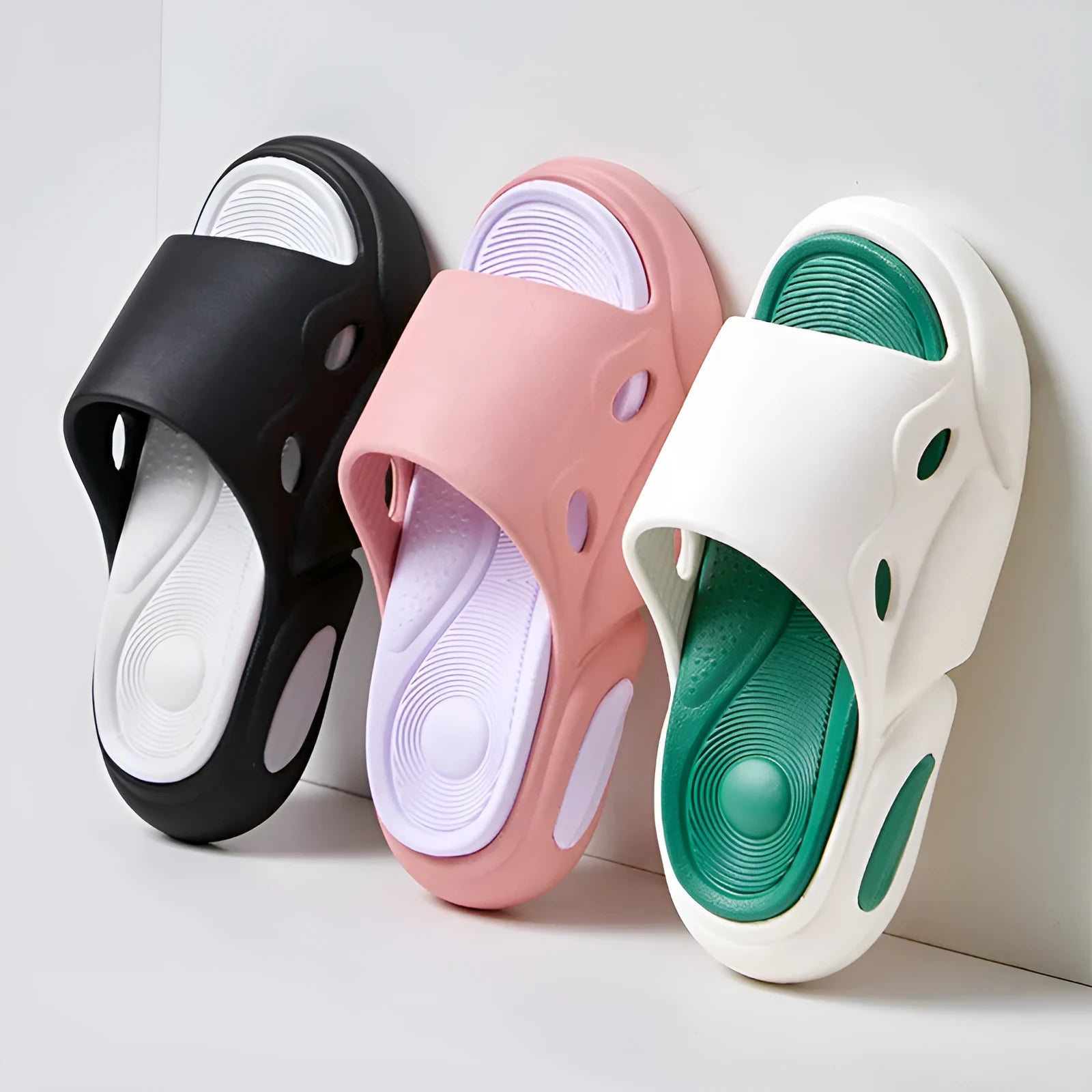 Two-colour EVA slippers with thick sole and leather lining in pink and purple.