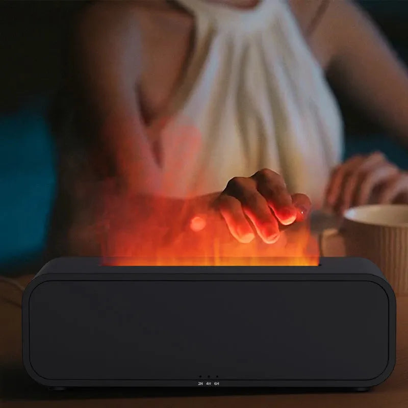 Black and white USB essential oil aromatherapy diffuser with colour-changing lights and remote control on a table