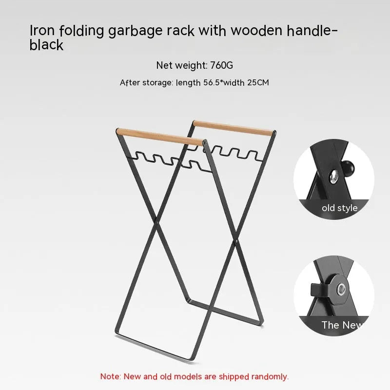 Black folding outdoor trash rack with wooden handle standing on a patio.