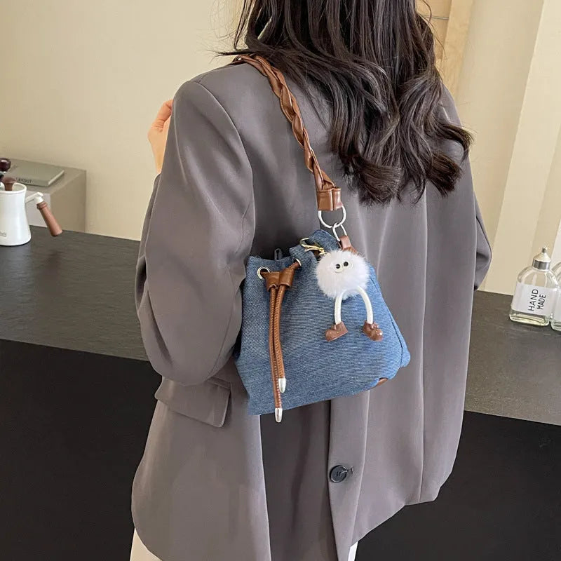 Blue synthetic leather cross body bucket bag with messenger design and shoulder strap