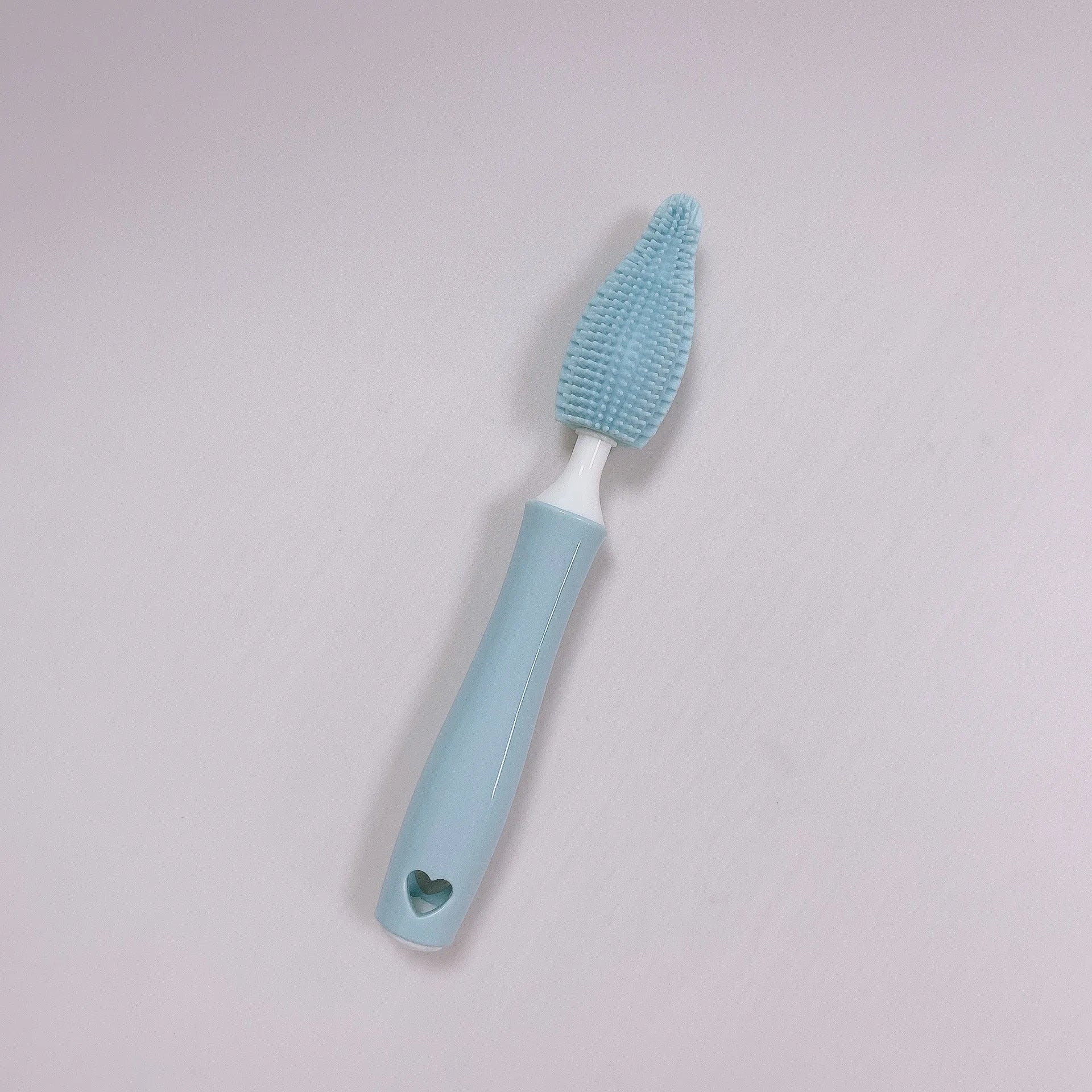 Three silicone baby bottle brushes in blue, pink, and yellow with straw scrubber on white background