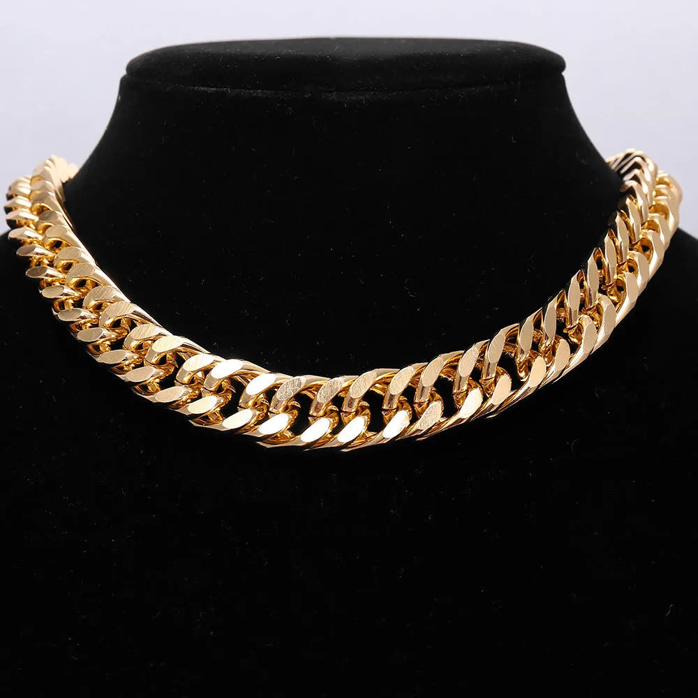 Gold women's thick link chain necklace with a 6cm drop pendant on a model.