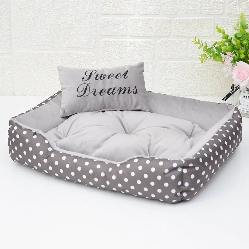 Small polka dot print square dog bed with a matching square pillow inside, shown in grey colour.