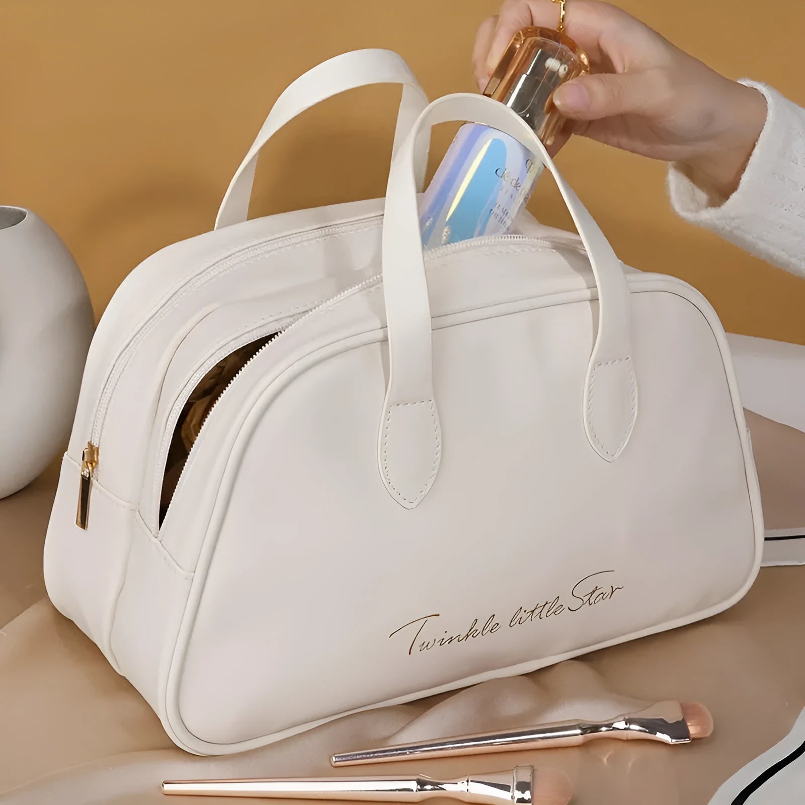 Leather travel toiletry bag open showing dry-wet separation compartments in caramel mocha colour