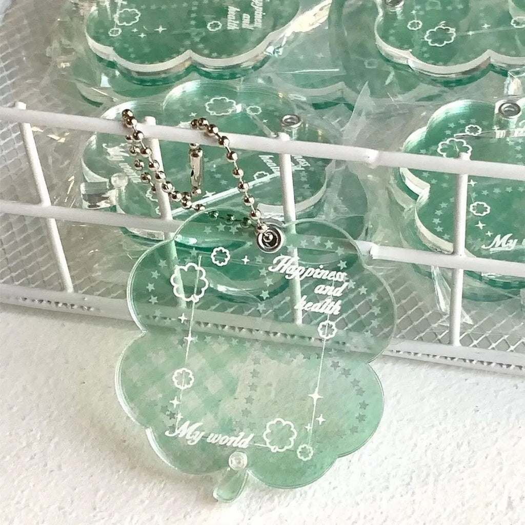 Acrylic four-leaf clover charm pendant keychain in blue, green, and mint colour options