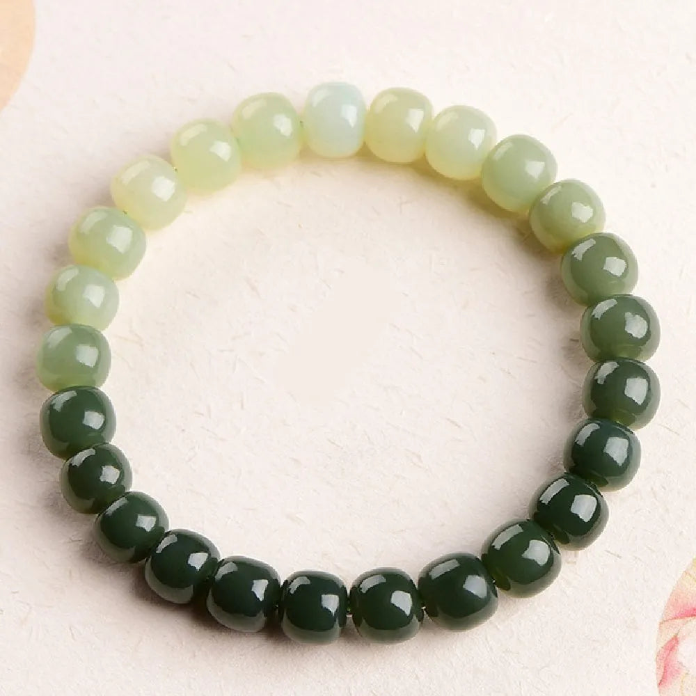 Natural Hetian jade bracelet with gradient clear water colour and polished beads.