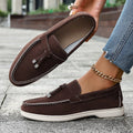 A pair of solid-colour platform slip-on loafers with a round toe and canvas upper.