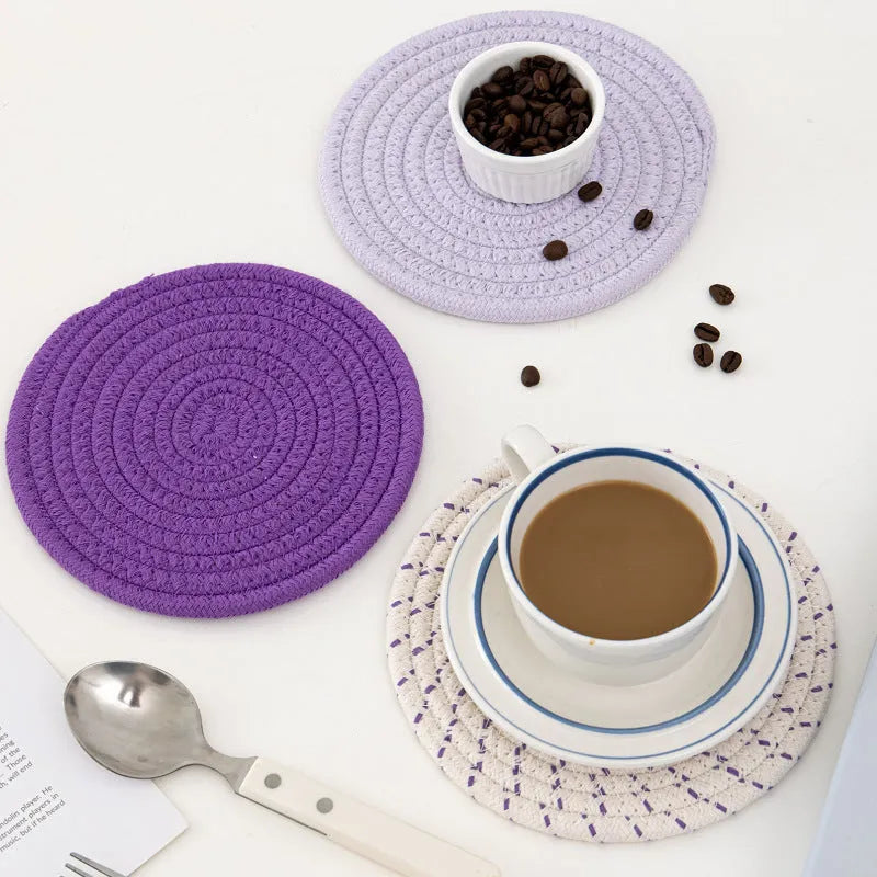 Three round cotton cord coasters in 18cm diameter showing grey, pink, purple and blue colour options