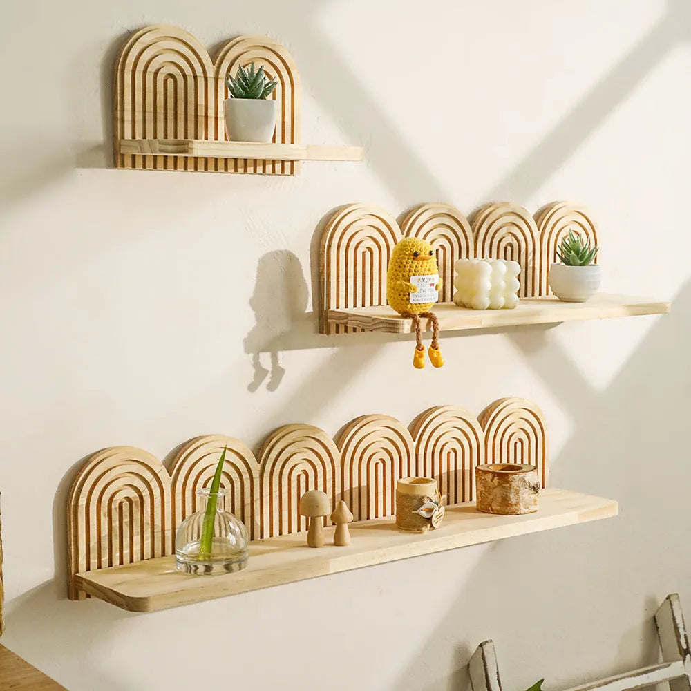 Solid wood multi-layer wall shelf holding several small potted plants.