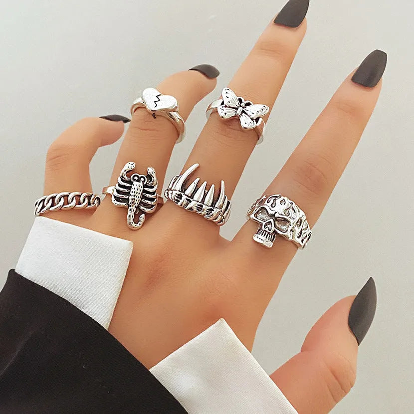 Alloy ring set with butterfly and snake retro geometric designs on display
