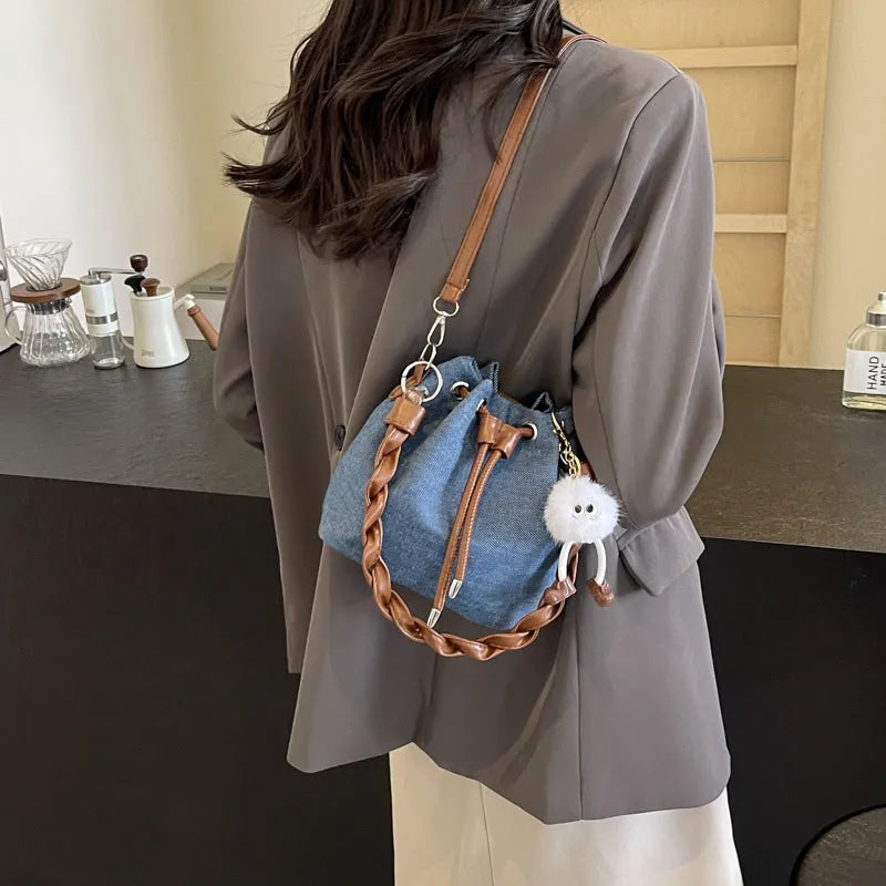 Blue synthetic leather cross body bucket bag with messenger design and shoulder strap