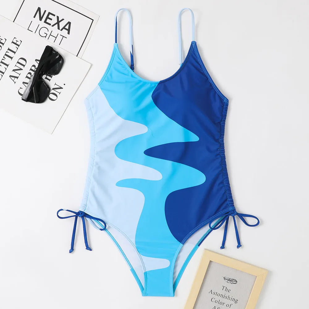 Women's blue sleeveless one-piece swimsuit with fixed trunks and backless design for swimming sports