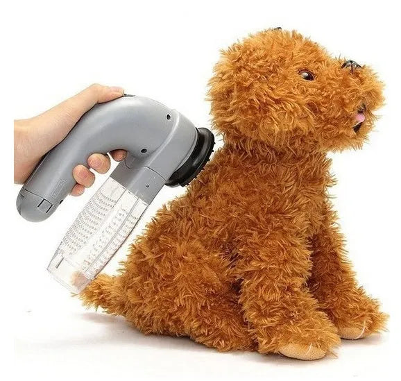 Grey portable pet hair vacuum cleaner with soft rubber head for grooming dogs and cats.