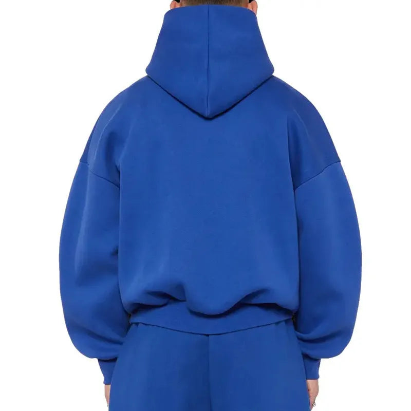 A man wearing a grey fleece-lined cotton pullover hoodie with a wool lining.