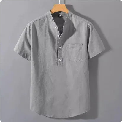 Man wearing a beige short sleeve linen and slub cotton casual shirt with a stand collar.