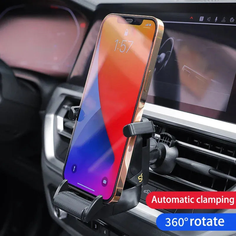 Gold car air vent phone holder with racing seat shape mounted on a car vent, showing 360-degree rotation.