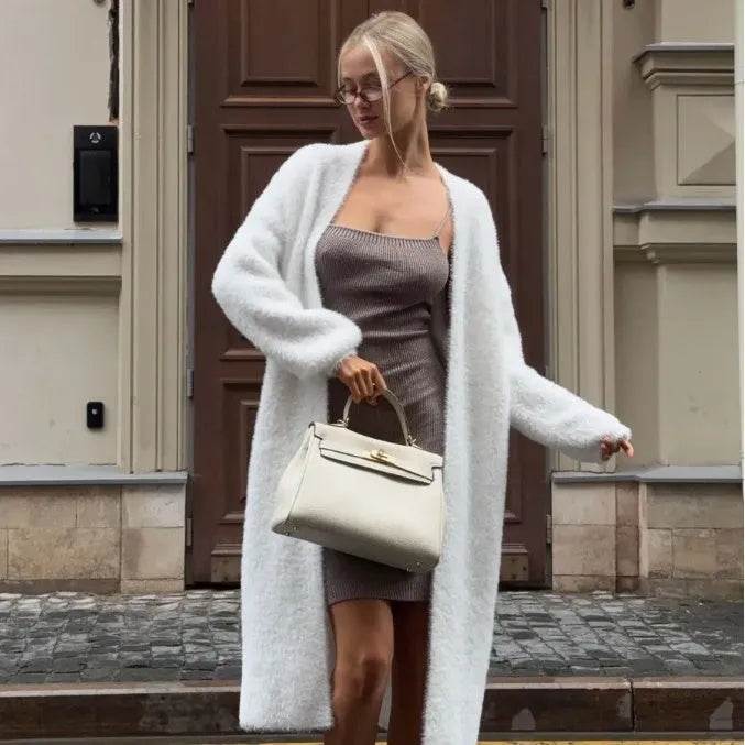 White knitted women's cardigan jacket with long sleeves and a loose, free-size fit