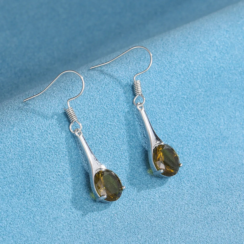 Olive green topaz coloured drop earrings with a water drop shape and retro style on a white background.