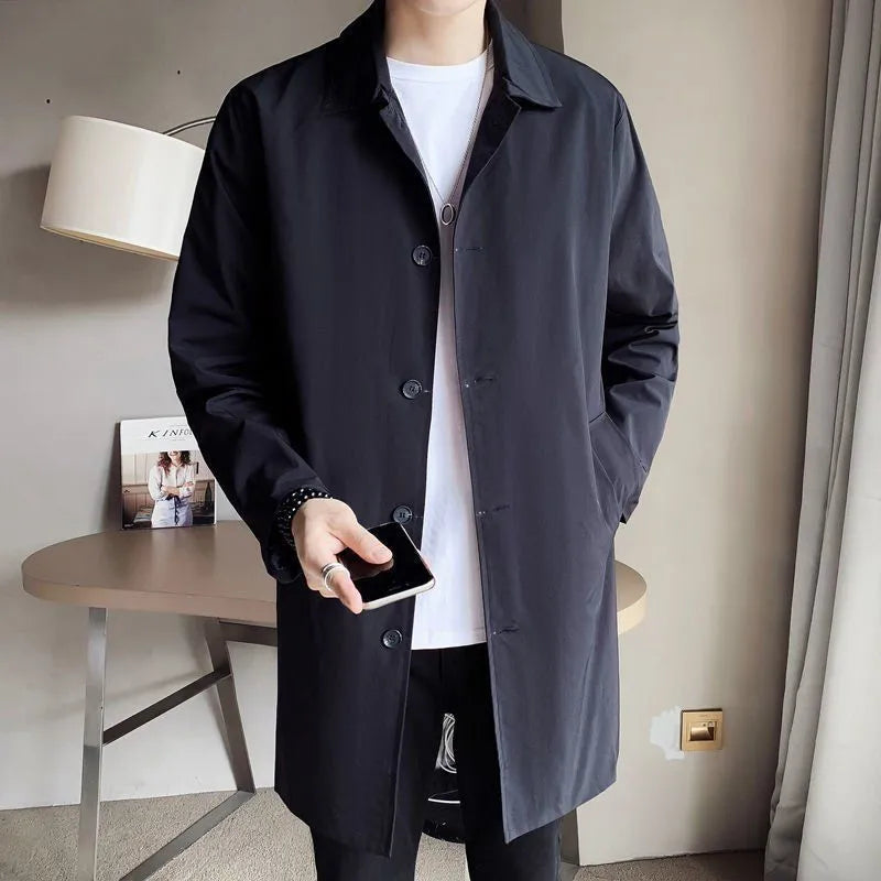Man wearing a khaki-coloured, loose-fit mid-length trench coat made of rabbit fur.