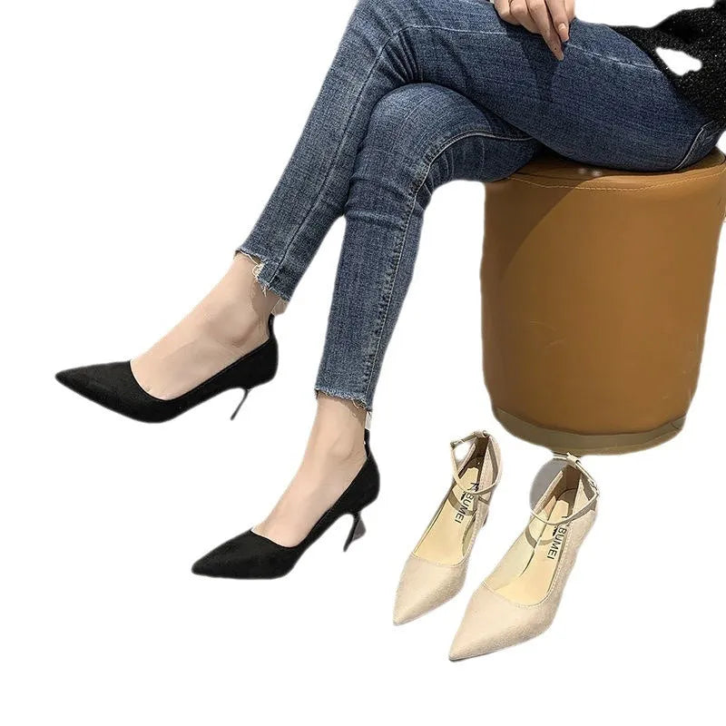 Black women's stiletto heel pump shoe with a skull pattern and a buckle fastening.