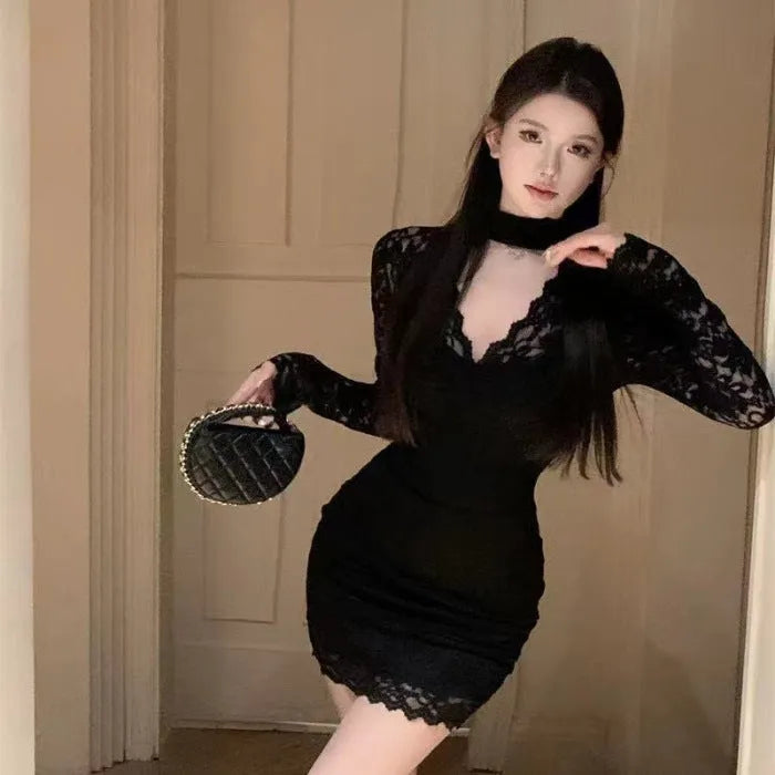 Women's black halter neck lace dress with A-line skirt and inner lining on a mannequin