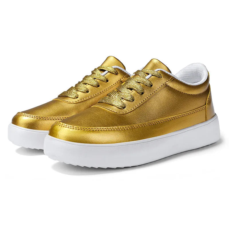 Women's leather flat casual shoes in gold colour with front lace-up closure on a white background.