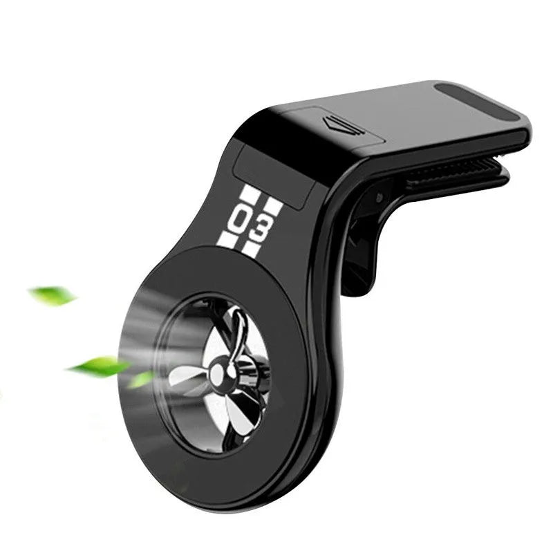 Black magnetic car phone holder clipped to a car air vent, showing a smartphone attached and the 360-degree rotating bracket.