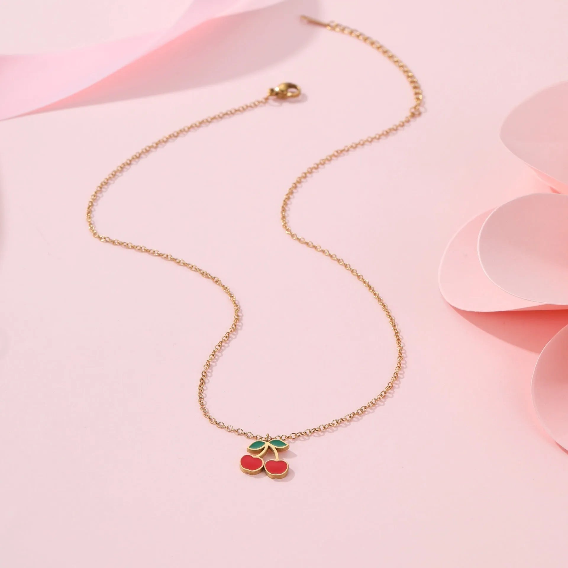 Cherry jewellery set showing necklace, bracelet, earrings, and ring with stainless steel construction
