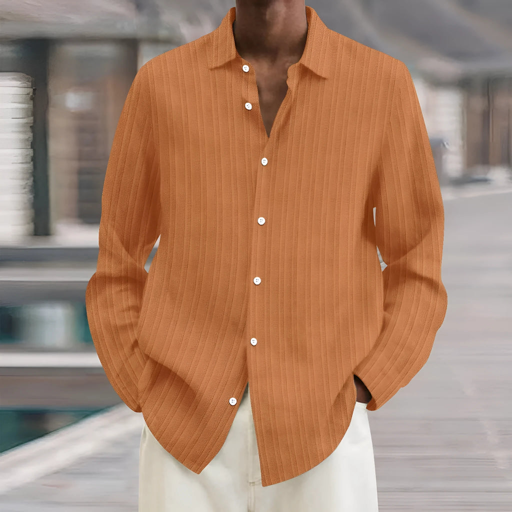 A man's loose-fit striped cardigan shirt with long sleeves in a British style design.