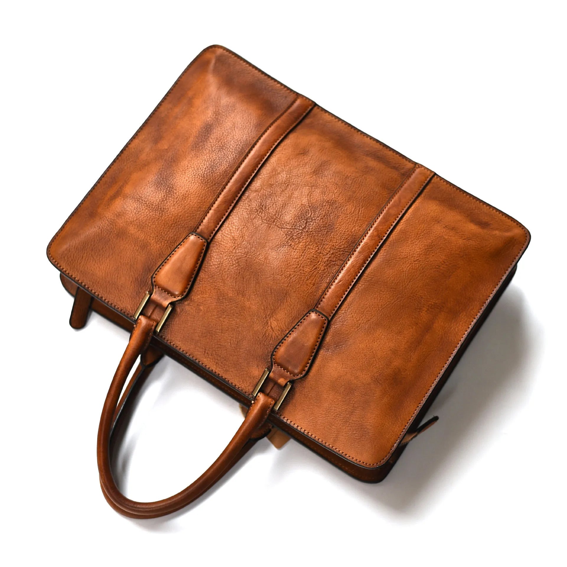 Men's brown leather horizontal business handbag with zipper, shown next to a 14-inch laptop for scale.